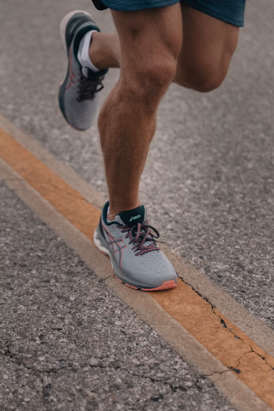Runner’s knees mid-stride, outdoors